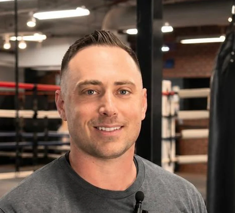 Coach Dean Moskowitz smiling in the gym